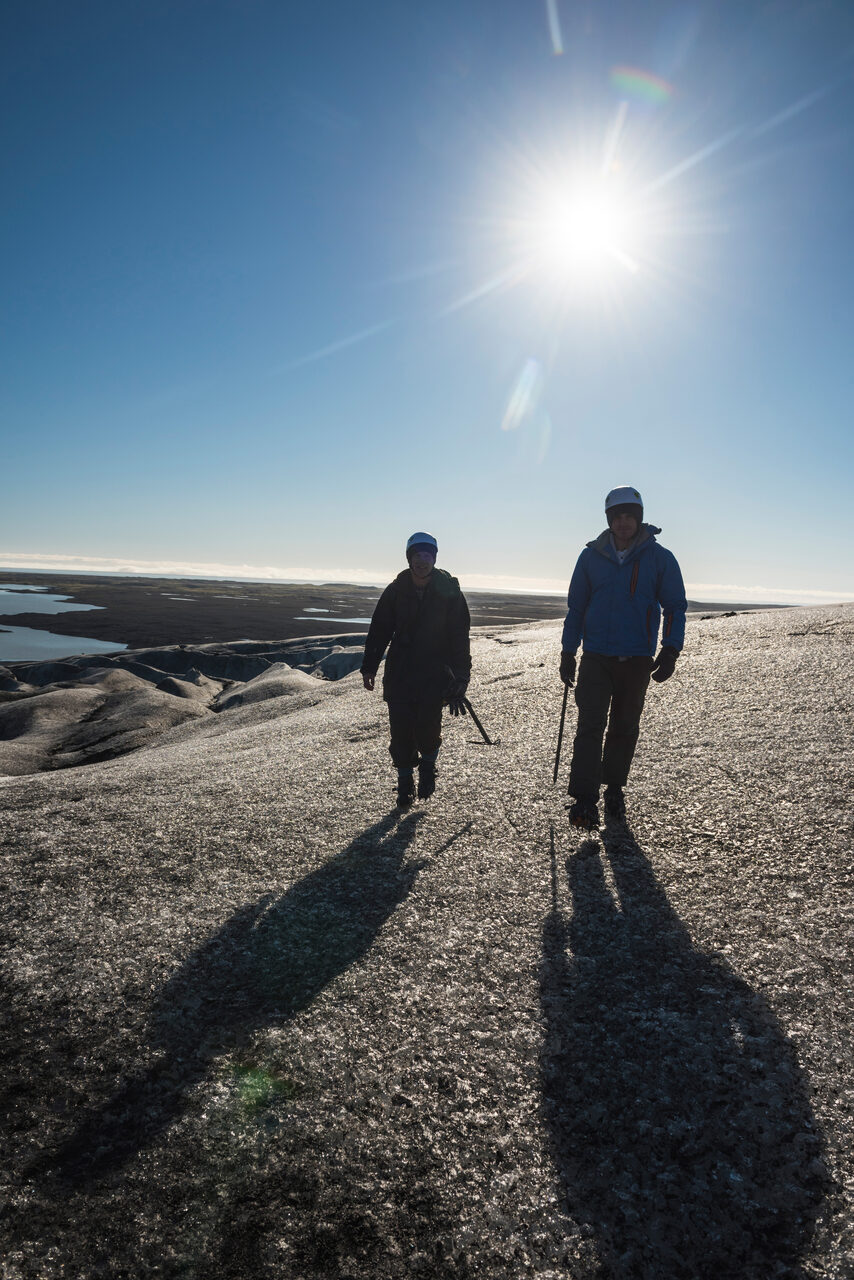Iceland Travel Photography Tourists walking on Breidamerkurjokull Glacier Vatnajokull Ice Cap Iceland