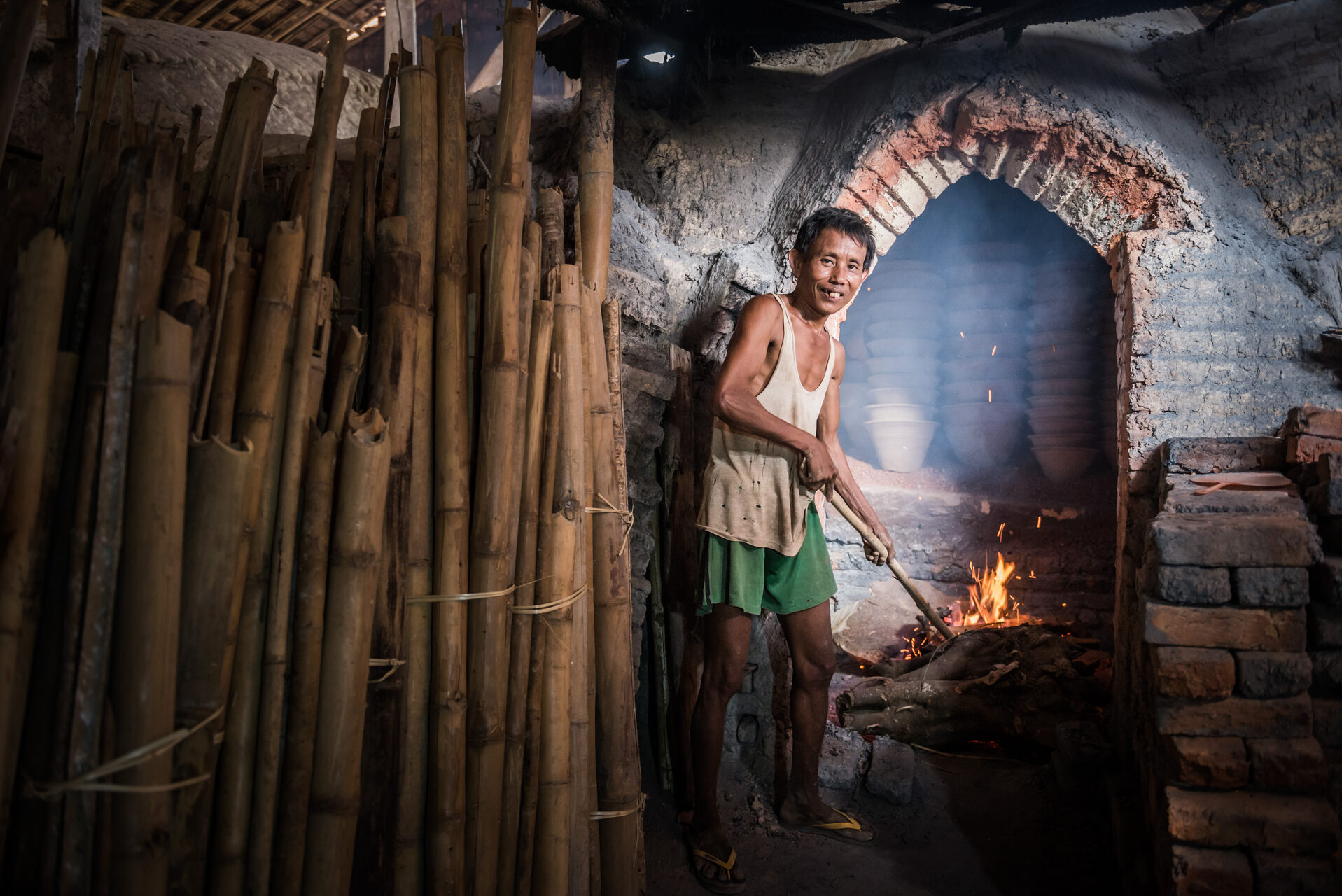 Myanmar Burma Portrait Travel Photography Documentary Portraiture Portrait of a potter in an Oh Bo pottery shed Twante near Yangon Myanmar Burma