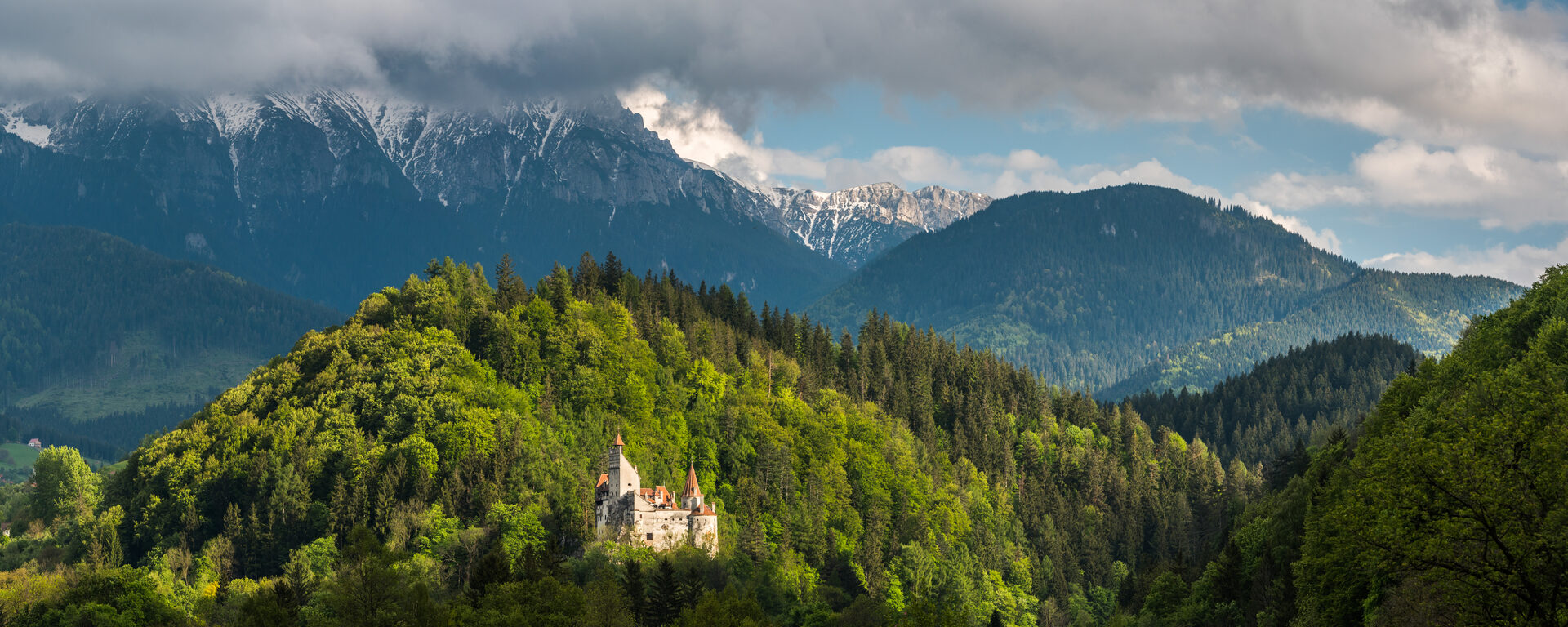 Romania Travel Photography Bran Castle Draculas Castle with Carpathian Mountains behind Transylvania Romania