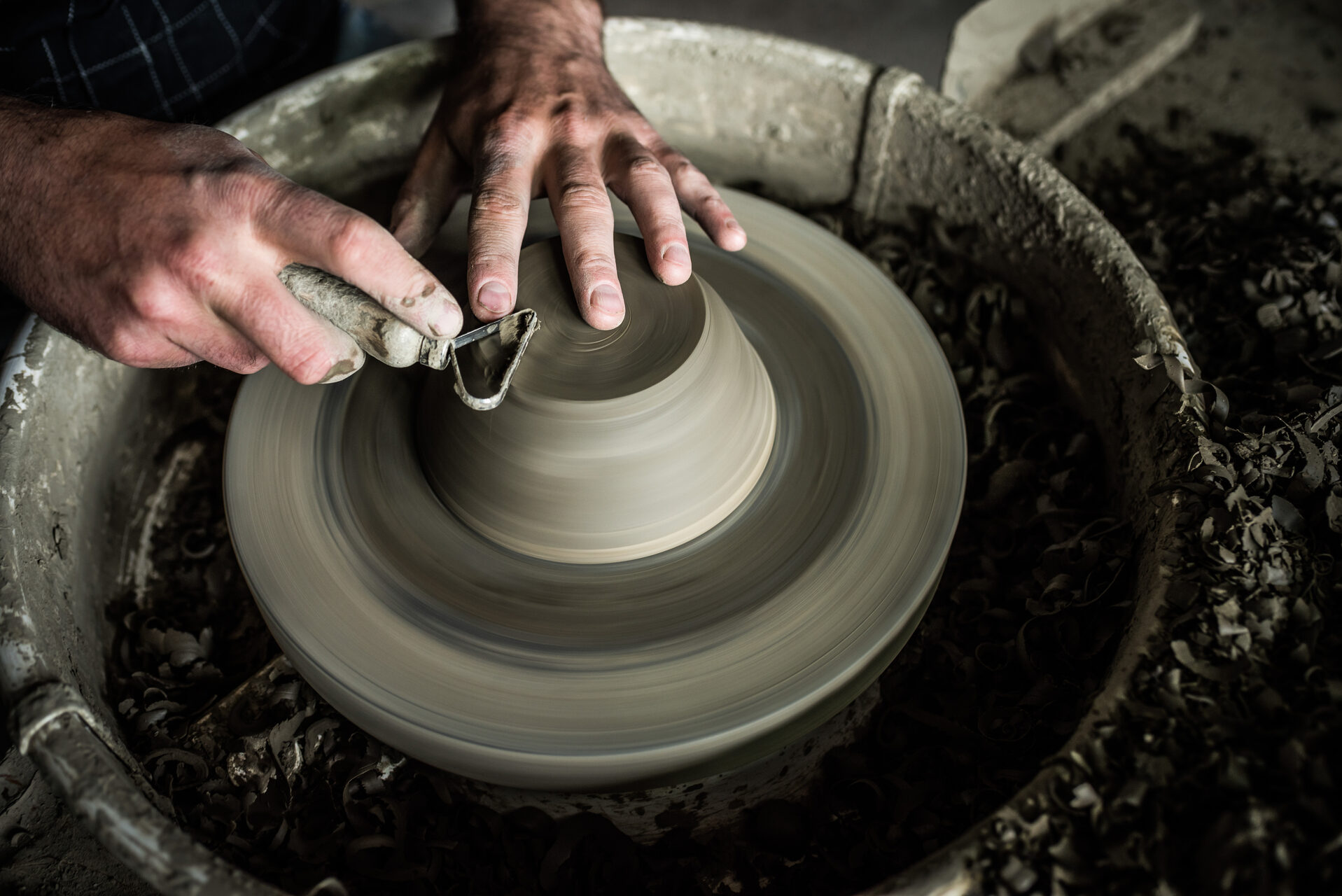 Romania Travel Photography Throwing a pot on a pottery wheel at a Marginea Black Pottery and Ceramics workshop Bukovina Romania