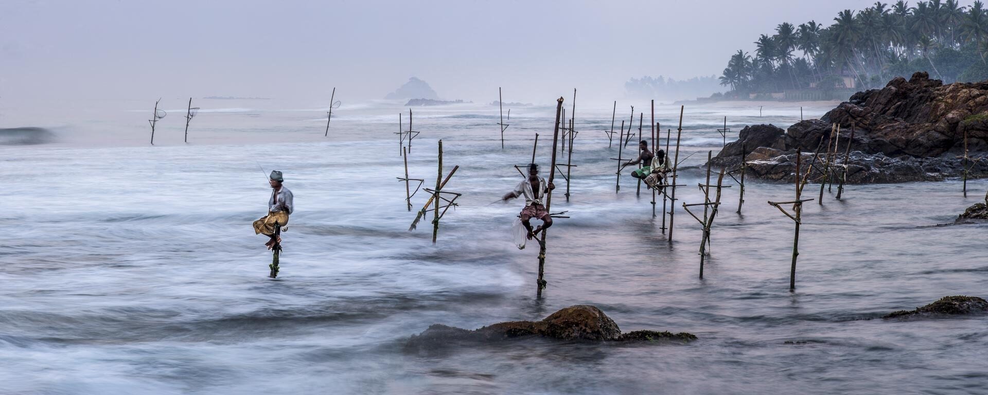 National Geographic Traveller Magazine Sri Lanka Article Stilt fishermen at Midigama Beach near Weligama South Coast Sri Lanka Asia